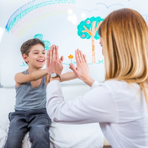 Pediatrician doing medical exam with boy
